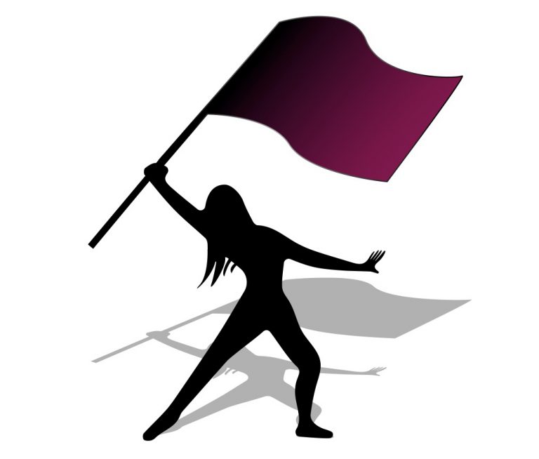 silhouette of woman holding flag
