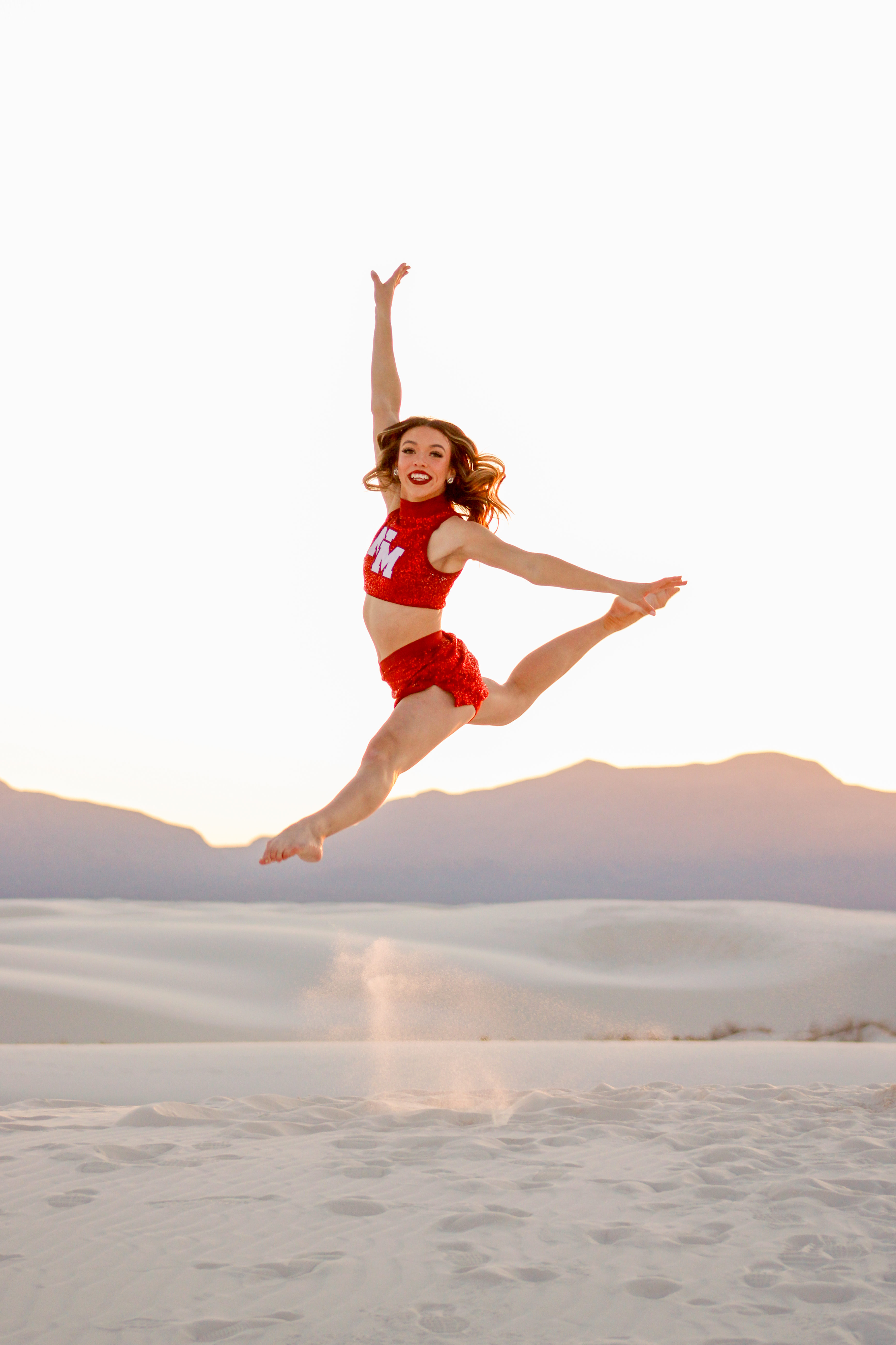Dancer jumping at white sands 